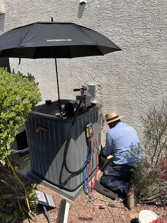 HVAC technician performing outdoor AC maintenance in Bessemer